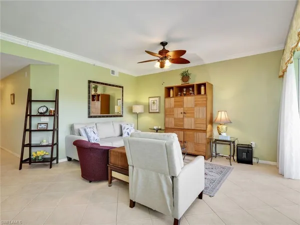 a living room with furniture a couch and a flat screen tv
