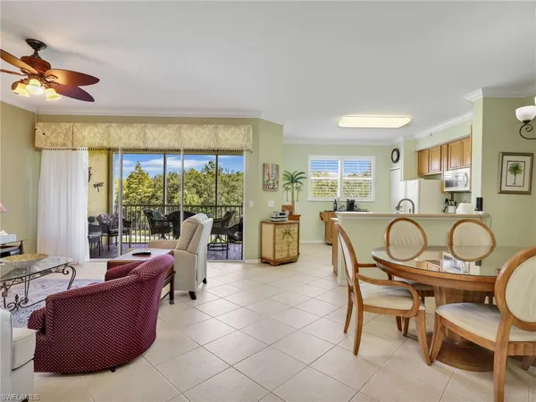 a room with furniture pool table and glass windows