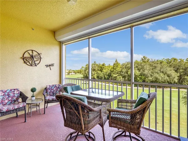 a view of a porch with furniture and a yard