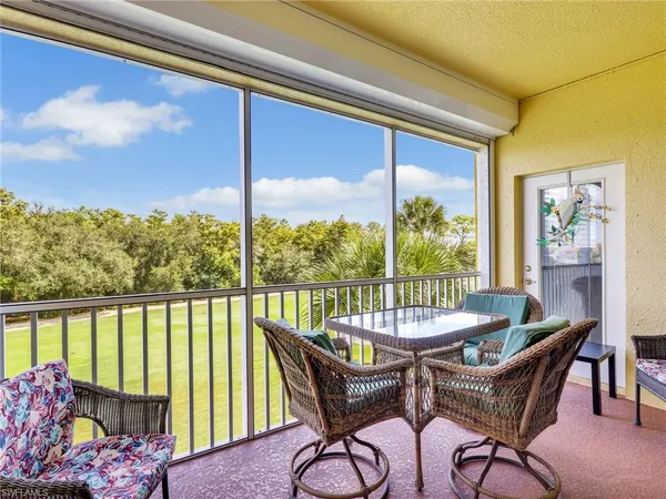 a dining room with furniture window and outside view