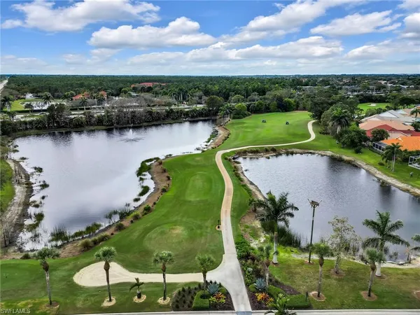 an aerial view of a house with a garden and lake view