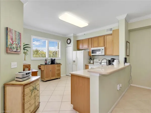 a kitchen with stainless steel appliances granite countertop a stove a sink dishwasher a refrigerator and cabinets with wooden floor