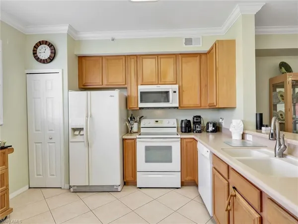 a kitchen with a sink cabinets and refrigerator