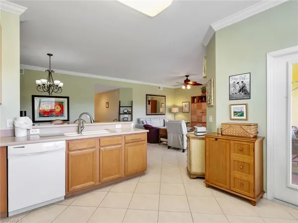 a large white kitchen with cabinets