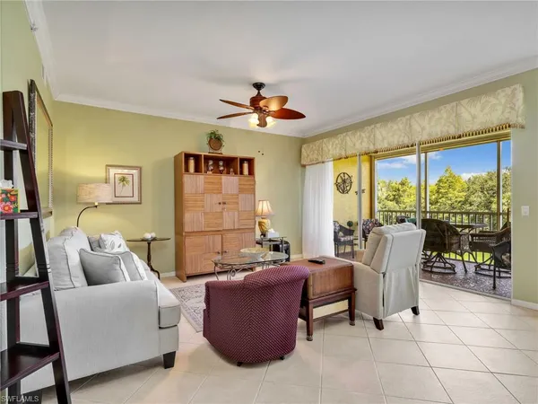 a living room with furniture a flat screen tv and a large window