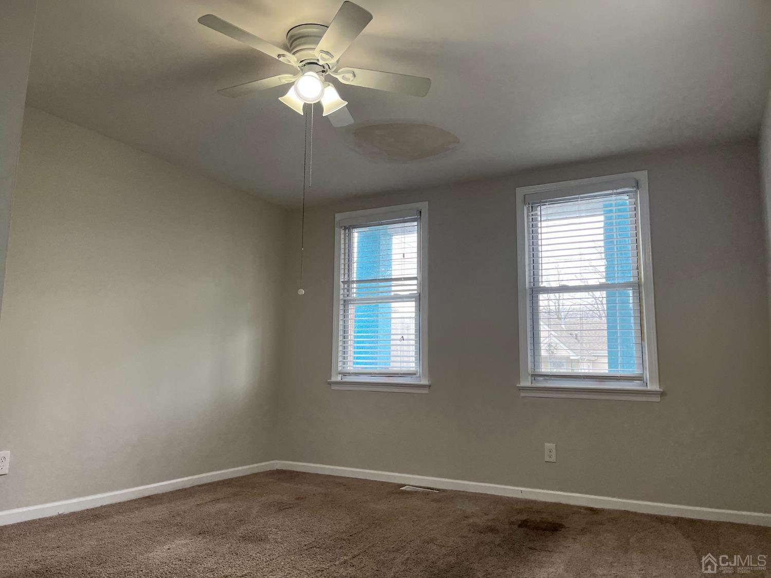 37 Thomas Street Perth Amboy, NJ 08861 - Photo 11 of 30 an empty room with windows and fan
