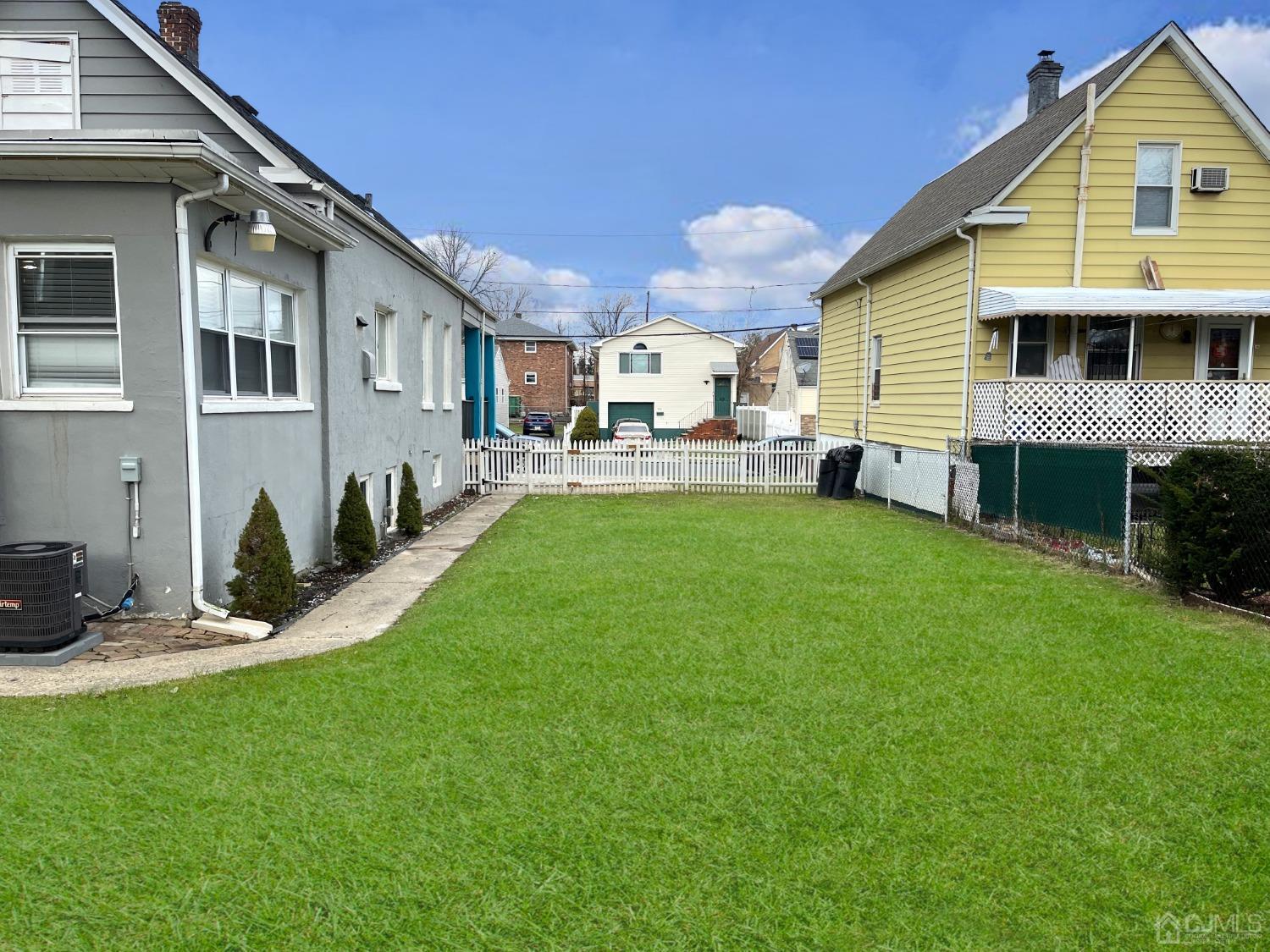 37 Thomas Street Perth Amboy, NJ 08861 - Photo 24 of 30 a front view of a house with a yard and sitting area