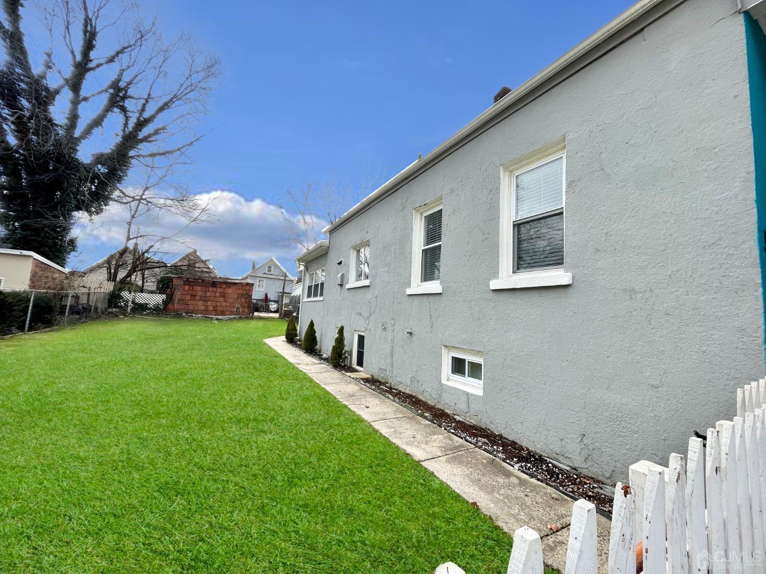 37 Thomas Street Perth Amboy, NJ 08861 - Photo 29 of 30 a front view of a house with garden