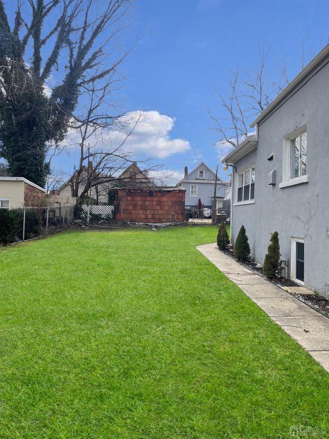 37 Thomas Street Perth Amboy, NJ 08861 - Photo 30 of 30 a view of a house with a big yard and large trees