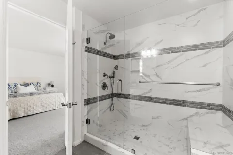 a bathroom with a glass shower door and a bathtub