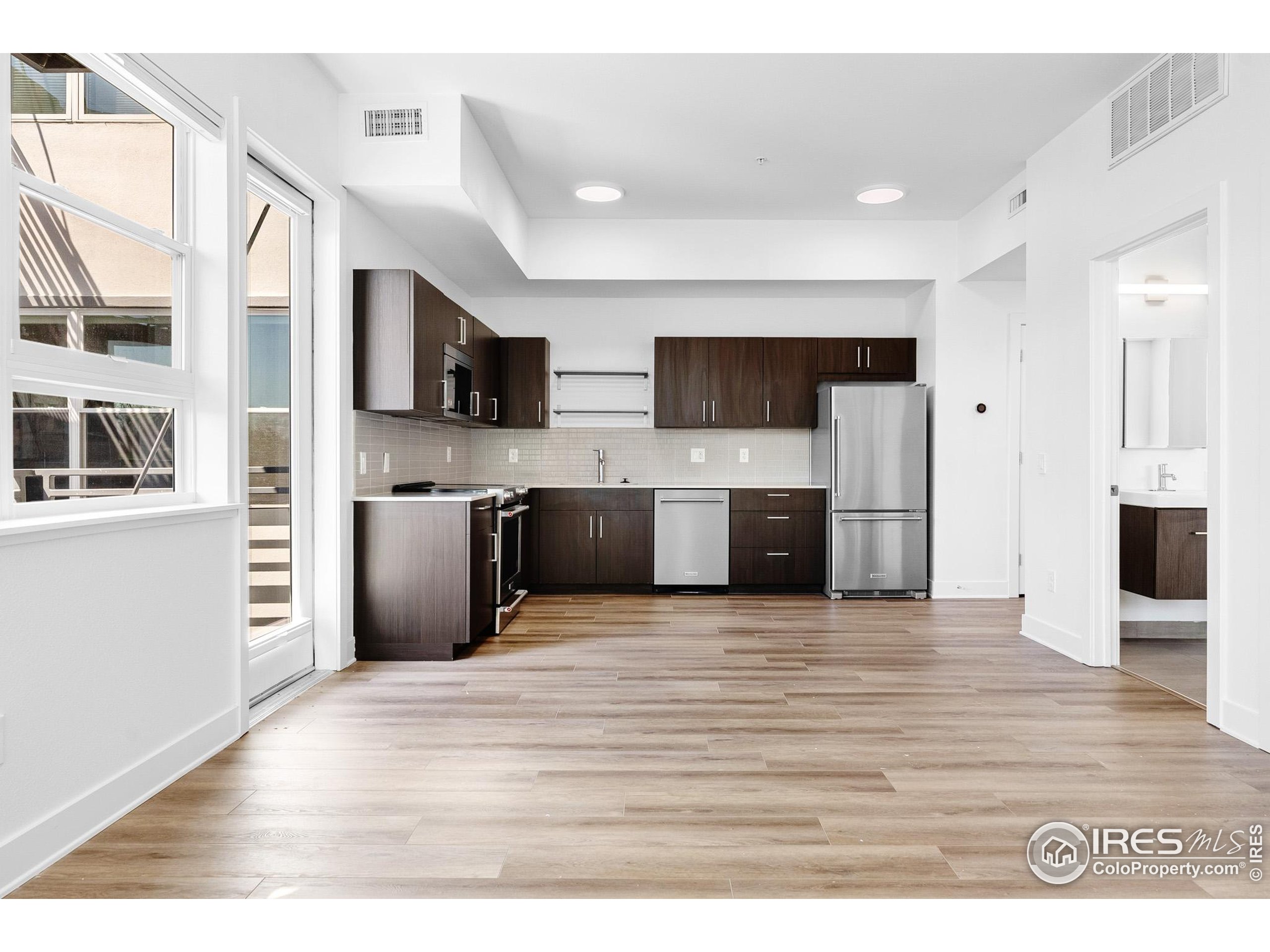 1707 Walnut Street, Unit 209 Boulder, CO 80302 - Photo 3 of 19 a view of living room kitchen with stainless steel appliances kitchen island