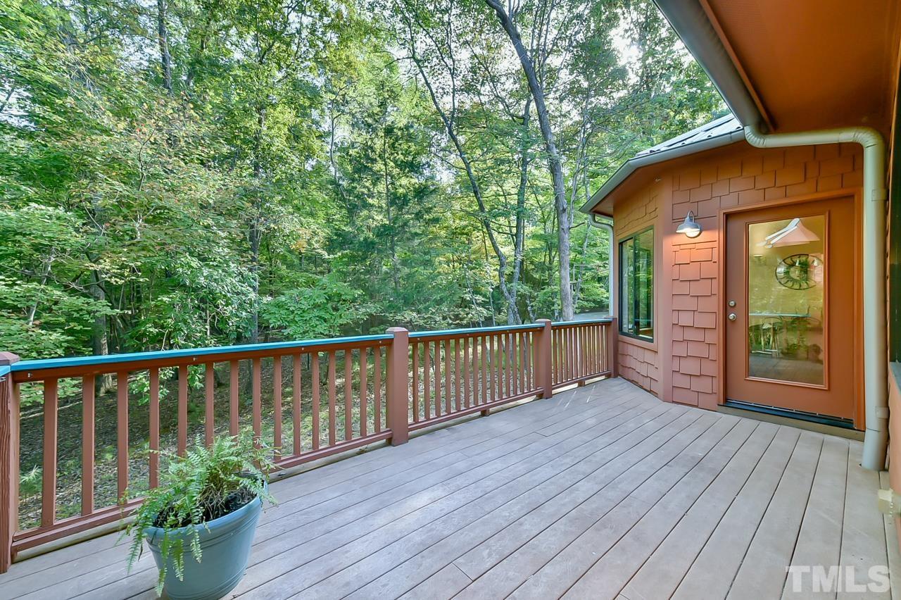 3616 Ragtime Road Hillsborough, NC 27278 - Photo 27 of 29 a balcony with wooden floor and yard in the back