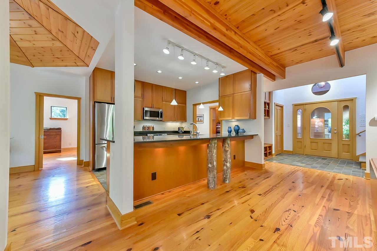 3616 Ragtime Road Hillsborough, NC 27278 - Photo 10 of 29 a view of a kitchen with stainless steel appliances granite countertop a refrigerator and a stove top oven