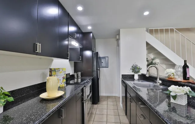 a kitchen with granite countertop lots of counter top space and stainless steel appliances