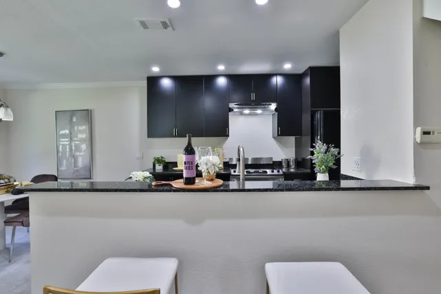 a kitchen with stainless steel appliances a sink and a refrigerator