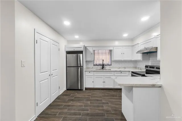 a view of a kitchen with a sink and cabinets