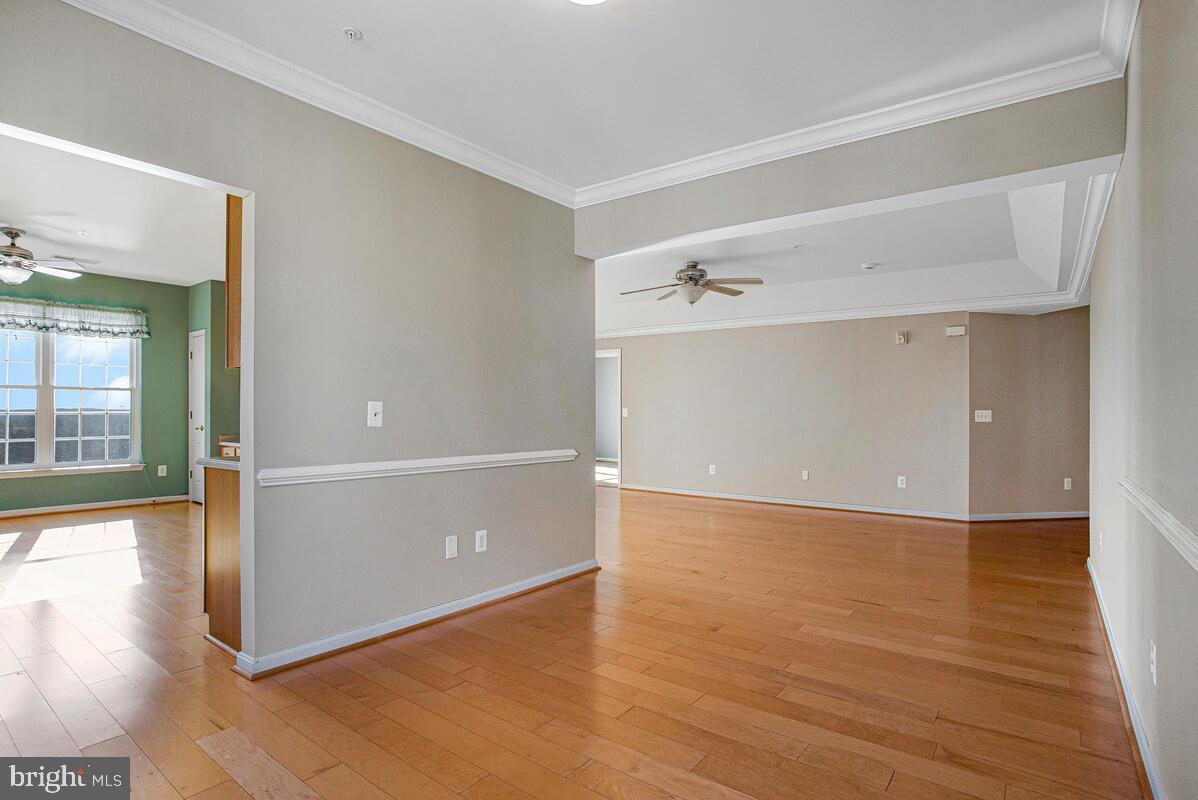 7325 Brookview Road, Unit 403 Elkridge, MD 21075 - Photo 12 of 65 a view of an empty room with wooden floor and a window