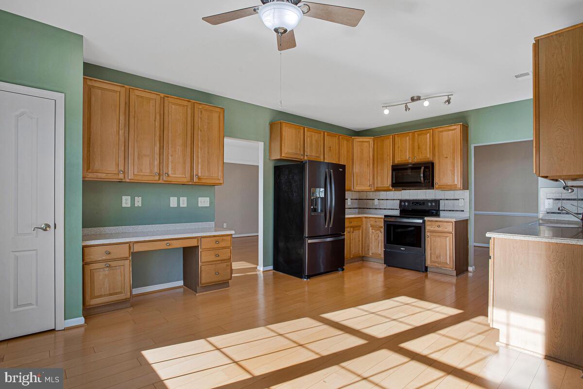 7325 Brookview Road, Unit 403 Elkridge, MD 21075 - Photo 14 of 65 a kitchen with stainless steel appliances granite countertop a refrigerator stove top oven and sink