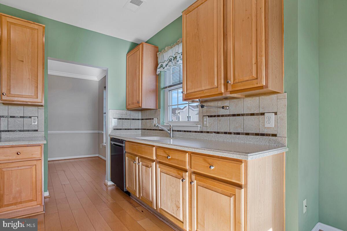 7325 Brookview Road, Unit 403 Elkridge, MD 21075 - Photo 16 of 65 a kitchen with stainless steel appliances granite countertop a sink and a cabinets with wooden floor