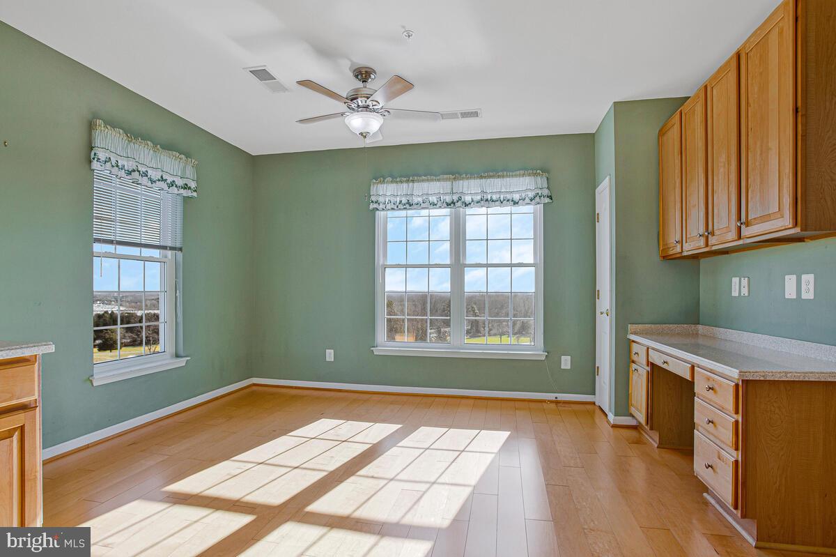 7325 Brookview Road, Unit 403 Elkridge, MD 21075 - Photo 20 of 65 a view of an empty room with a window and wooden floor