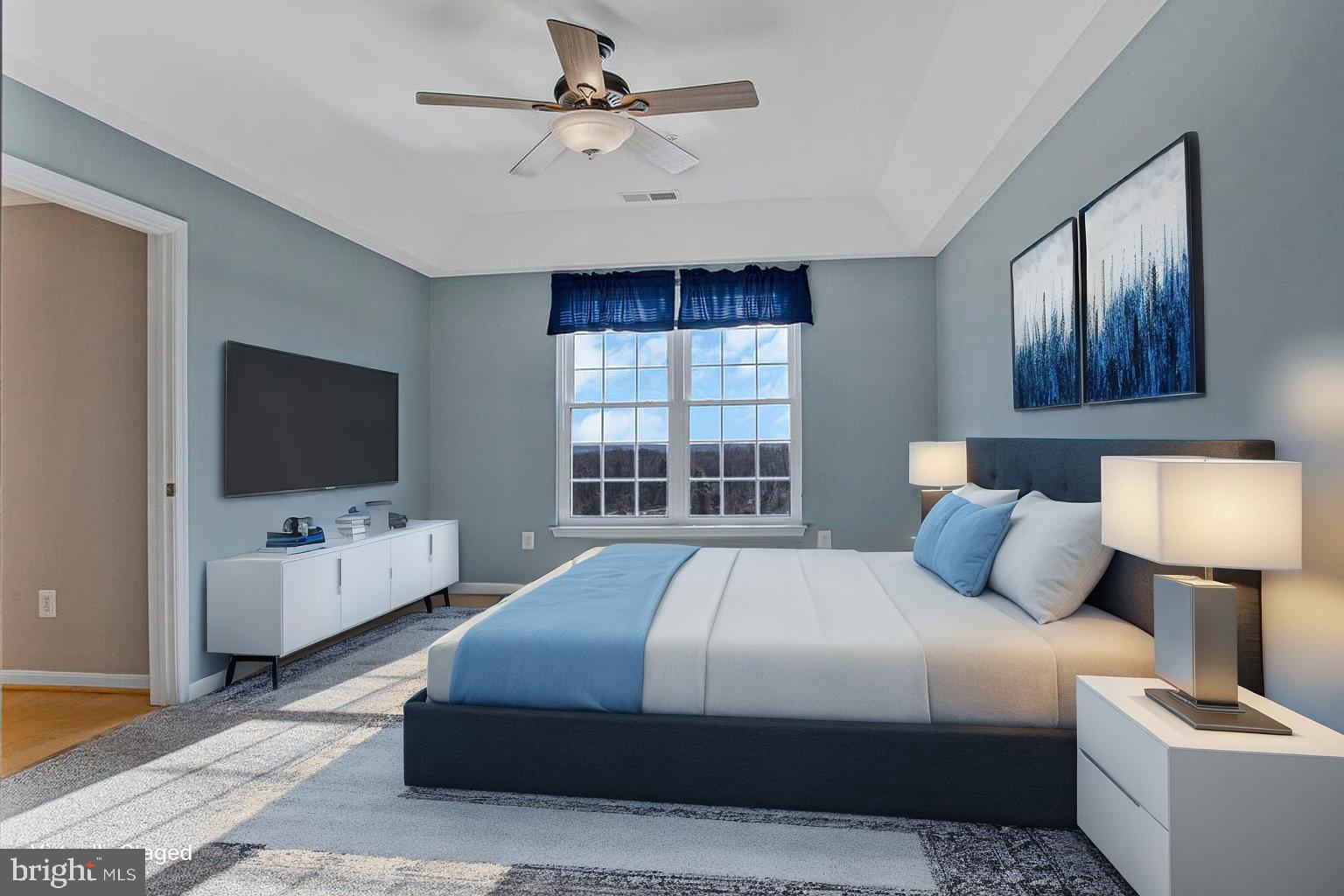 7325 Brookview Road, Unit 403 Elkridge, MD 21075 - Photo 21 of 65 a bedroom with a bed a flat screen tv and a couch