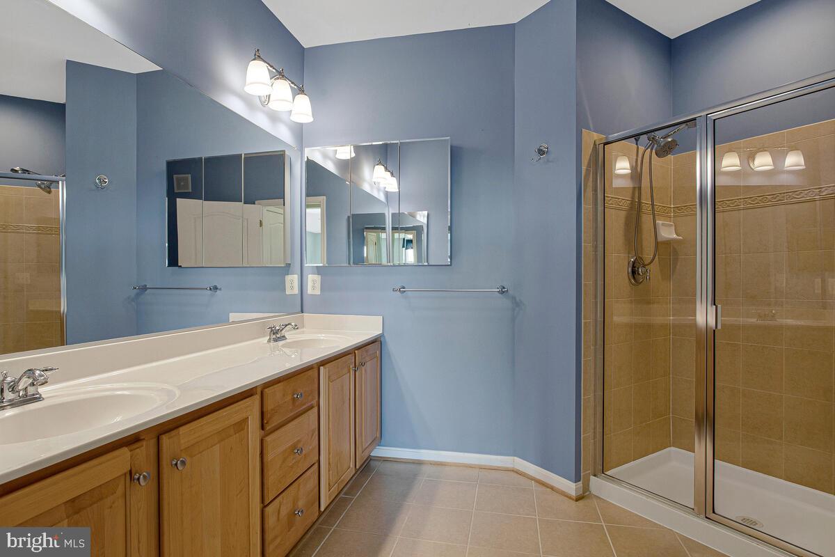 7325 Brookview Road, Unit 403 Elkridge, MD 21075 - Photo 25 of 65 a bathroom with a sink a shower and a mirror