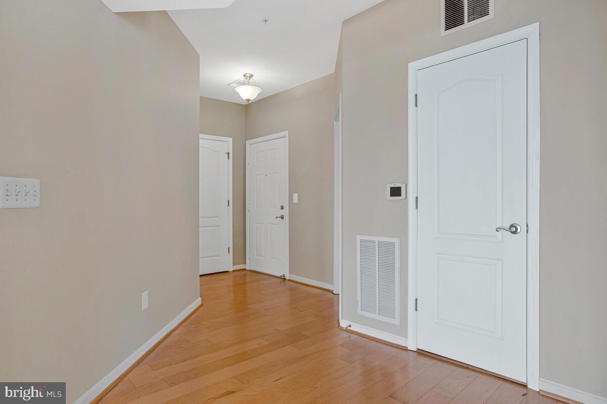 7325 Brookview Road, Unit 403 Elkridge, MD 21075 - Photo 3 of 65 a view of a hallway with wooden floor