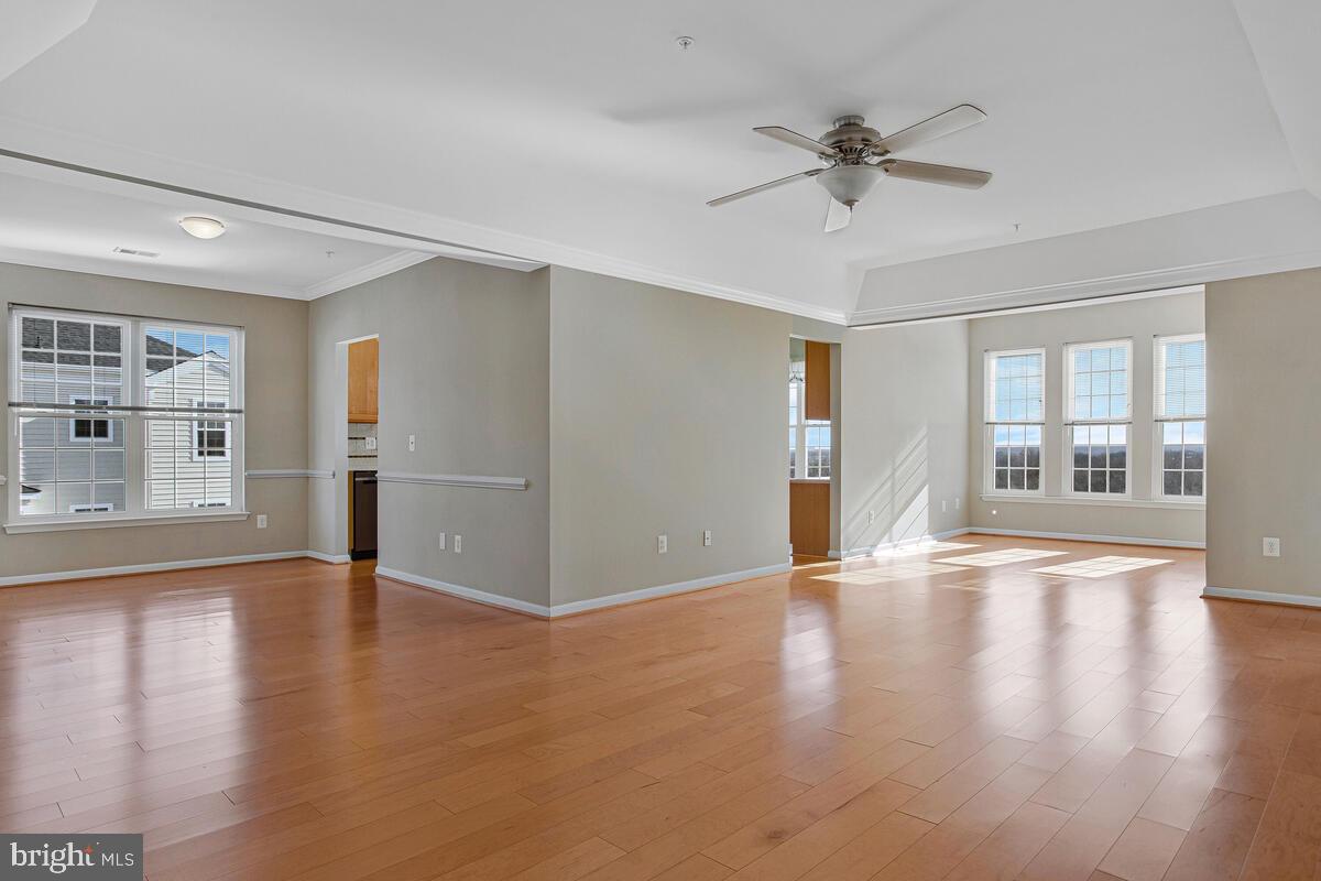 7325 Brookview Road, Unit 403 Elkridge, MD 21075 - Photo 5 of 65 a view of an empty room with wooden floor and a window
