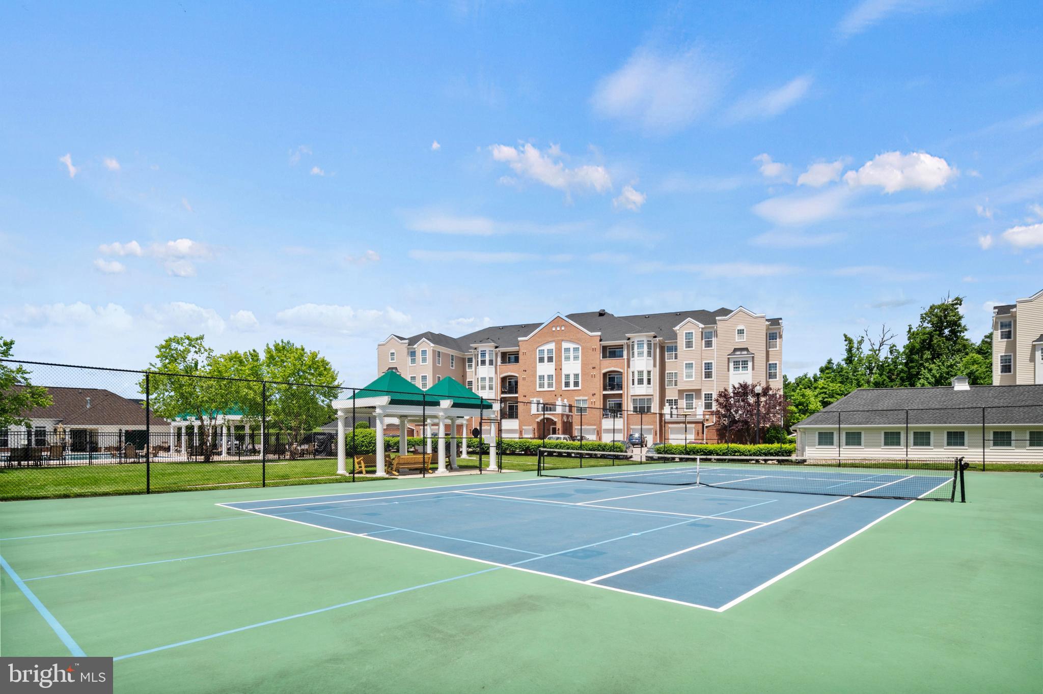 7325 Brookview Road, Unit 403 Elkridge, MD 21075 - Photo 62 of 65 a view of a big building with a big yard and large trees