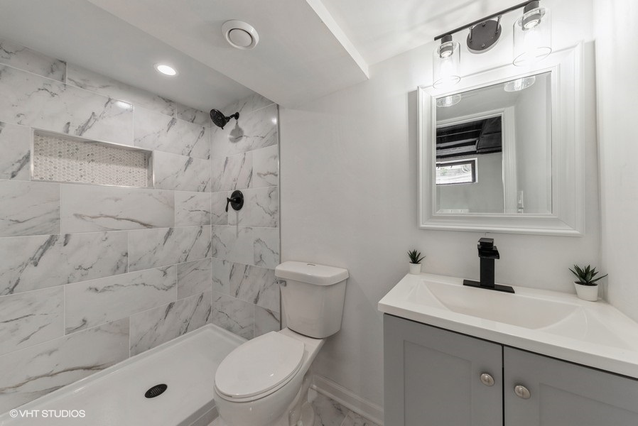 403 Highview Drive Fox River Grove, IL 60021 - Photo 11 of 18 a bathroom with a sink a toilet and shower