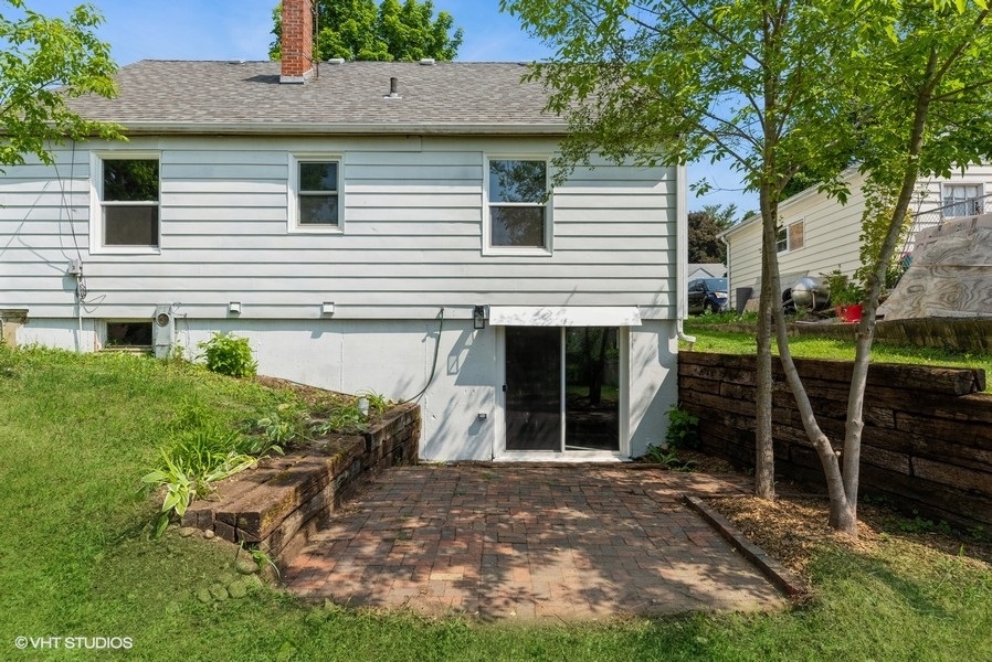 403 Highview Drive Fox River Grove, IL 60021 - Photo 12 of 18 a view of a house with backyard and a fire pit