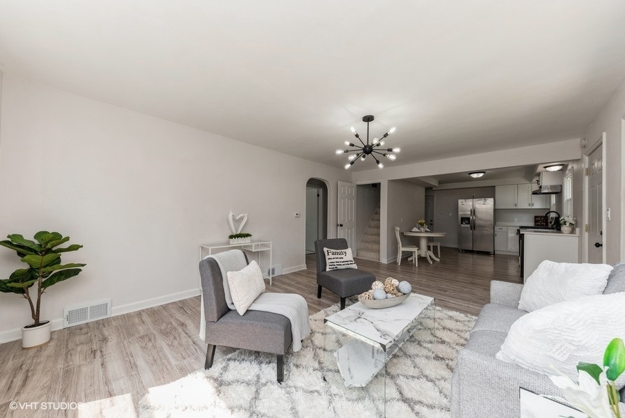 403 Highview Drive Fox River Grove, IL 60021 - Photo 3 of 18 a living room with furniture and a chandelier