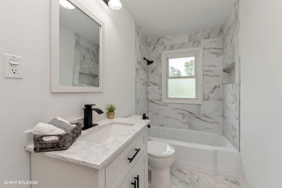 403 Highview Drive Fox River Grove, IL 60021 - Photo 7 of 18 a bathroom with a sink toilet and shower
