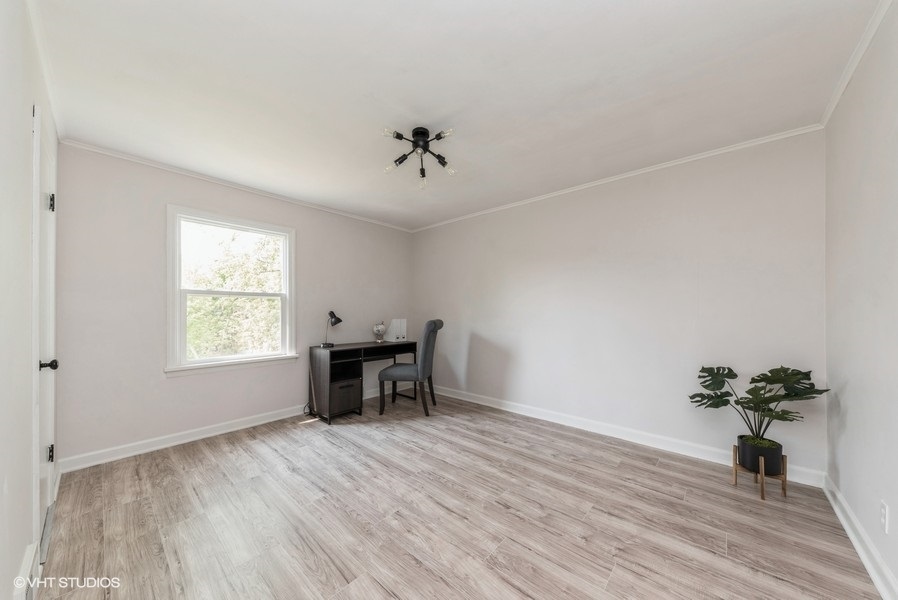 403 Highview Drive Fox River Grove, IL 60021 - Photo 9 of 18 a view of an empty room with a window and wooden floor