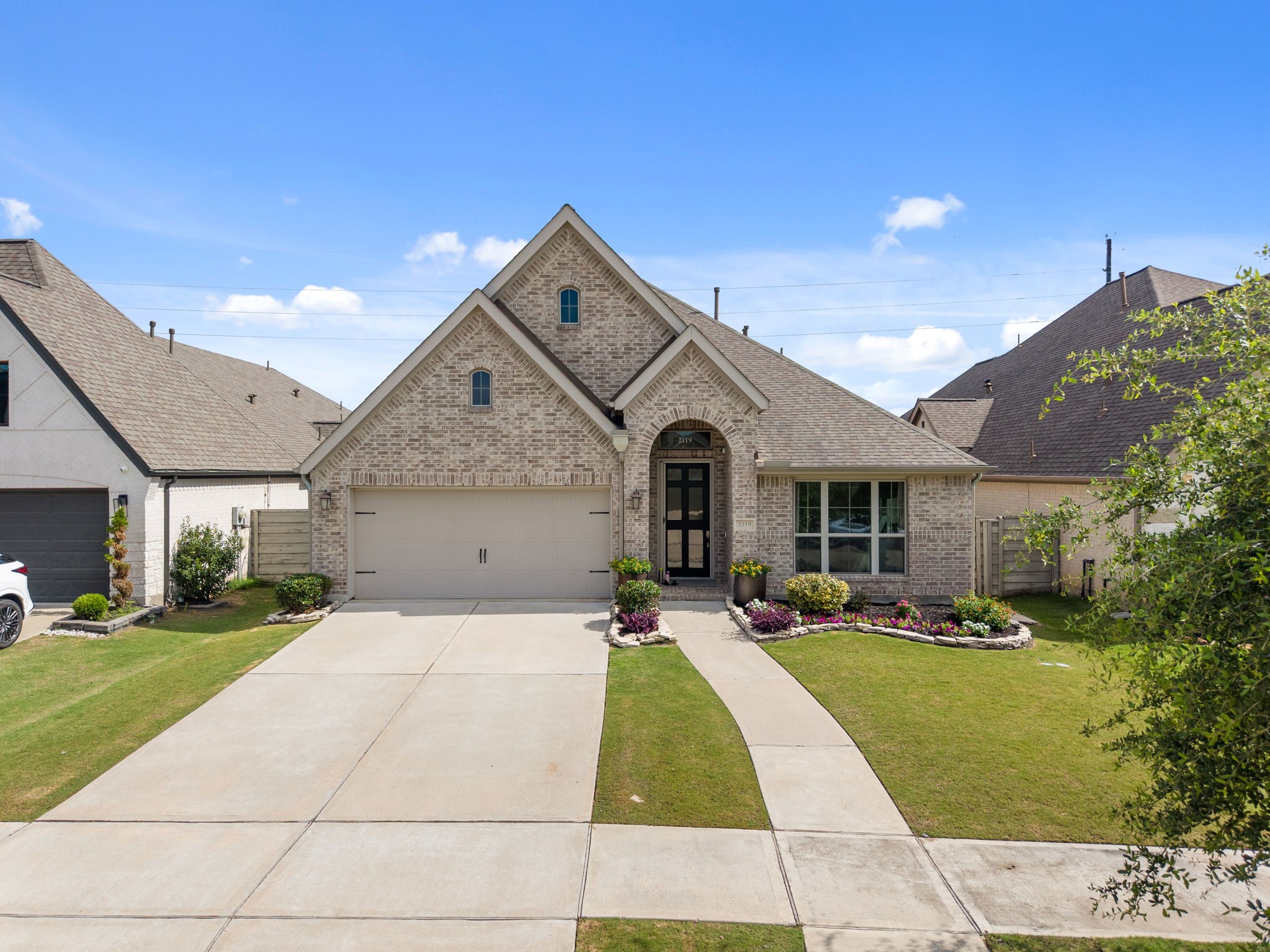 2119 Blackhawk Ridge Lane Manvel, TX 77578 - Photo 1 of 49 Stunning curb appeal with classic brick elevation, soaring roofline, and a beautifully landscaped front yard.