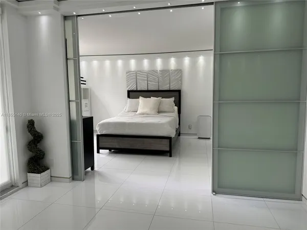 a bedroom with a bed and a shower