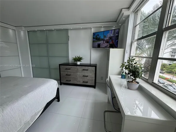 a bedroom with a bed and window