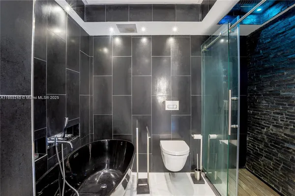 a bathroom with a toilet and a shower