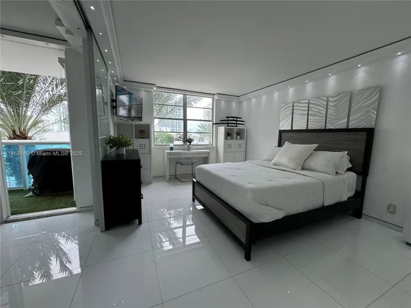 a bedroom with a bed and a television