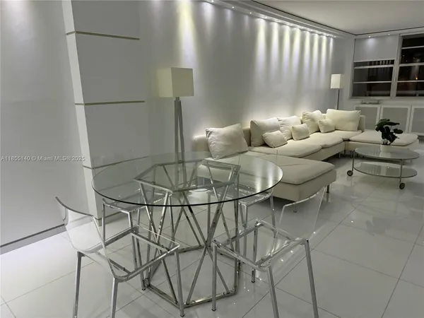 a living room with furniture and kitchen view