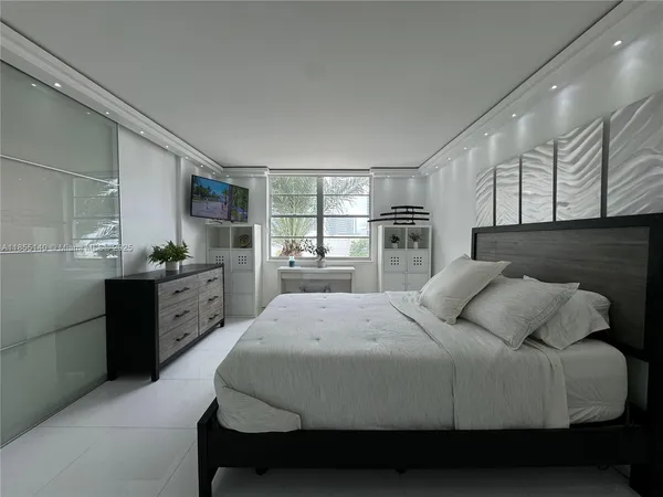 a bedroom with a large bed and a dresser