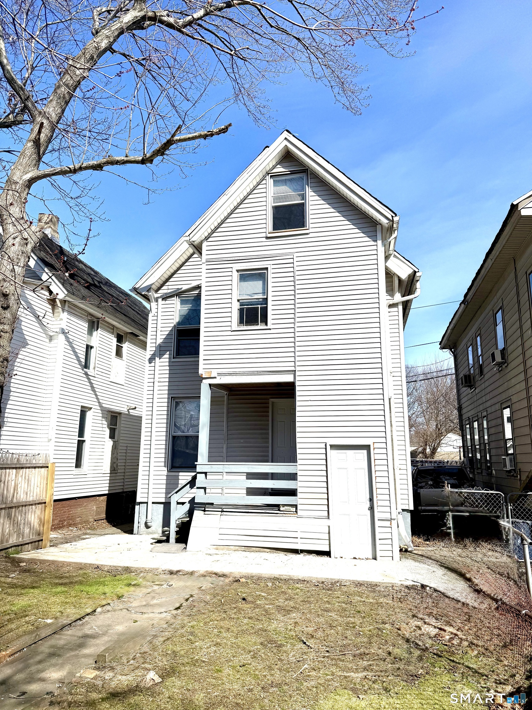 76 3rd Street New Haven, CT 06519 - Photo 20 of 20 a view of a house with wooden stairs and a car parked in front of it