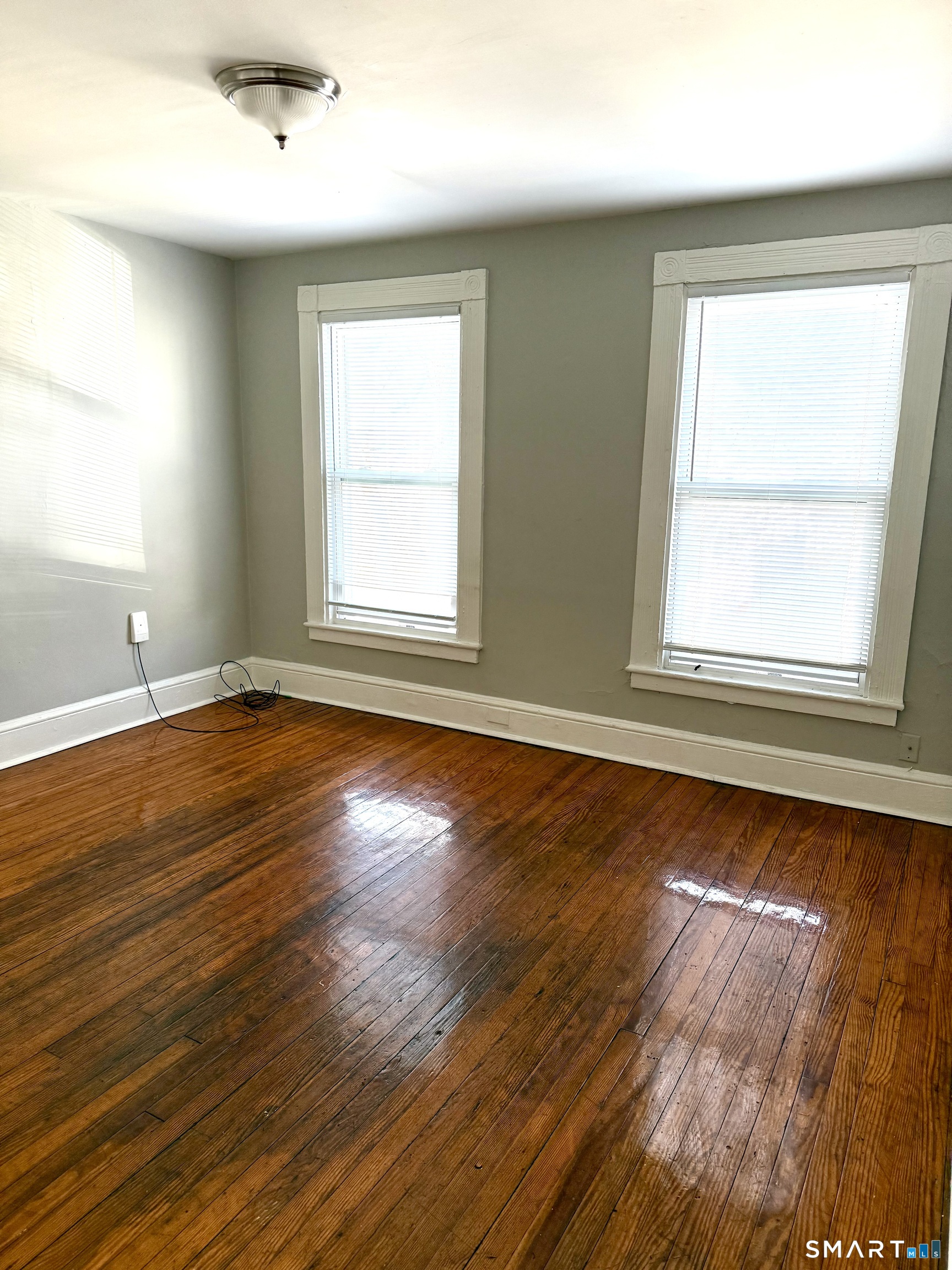 76 3rd Street New Haven, CT 06519 - Photo 3 of 20 an empty room with wooden floor and windows