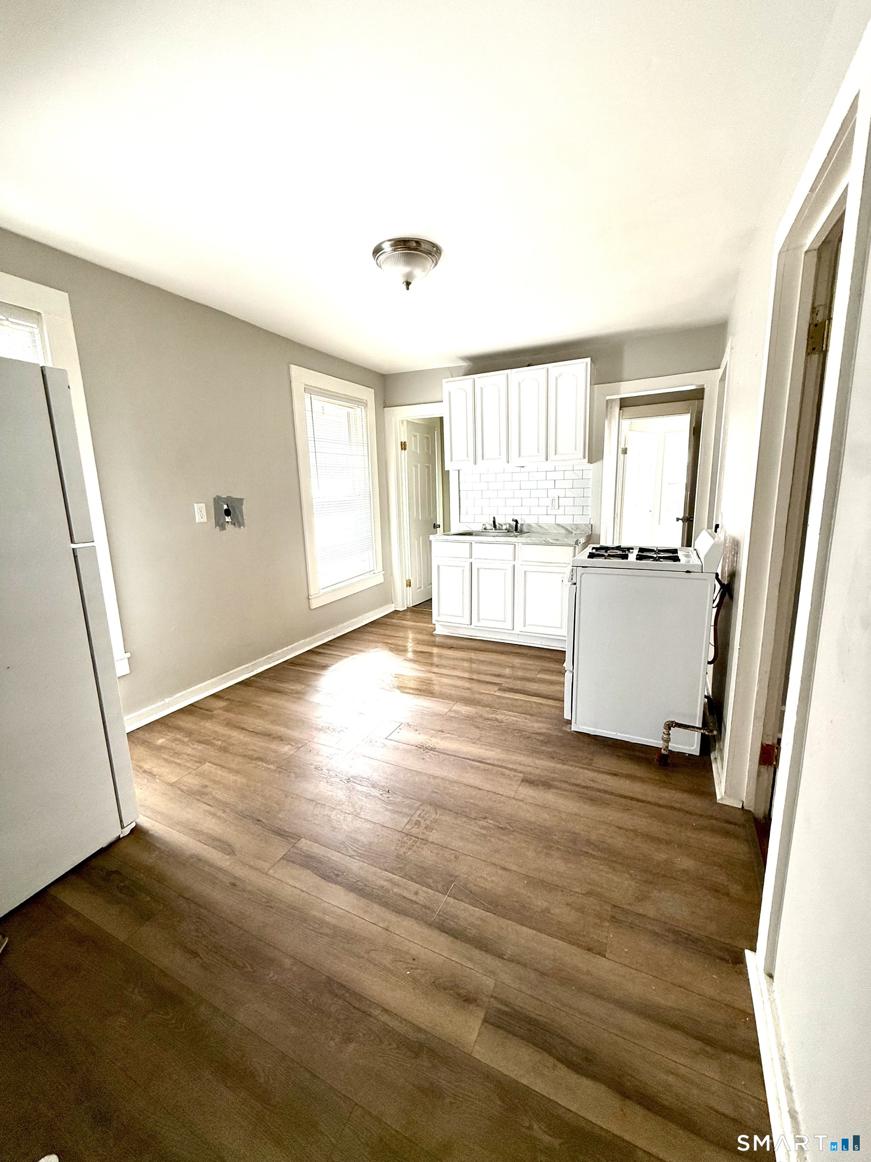 76 3rd Street New Haven, CT 06519 - Photo 4 of 20 a view of a kitchen with wooden floor and a sink