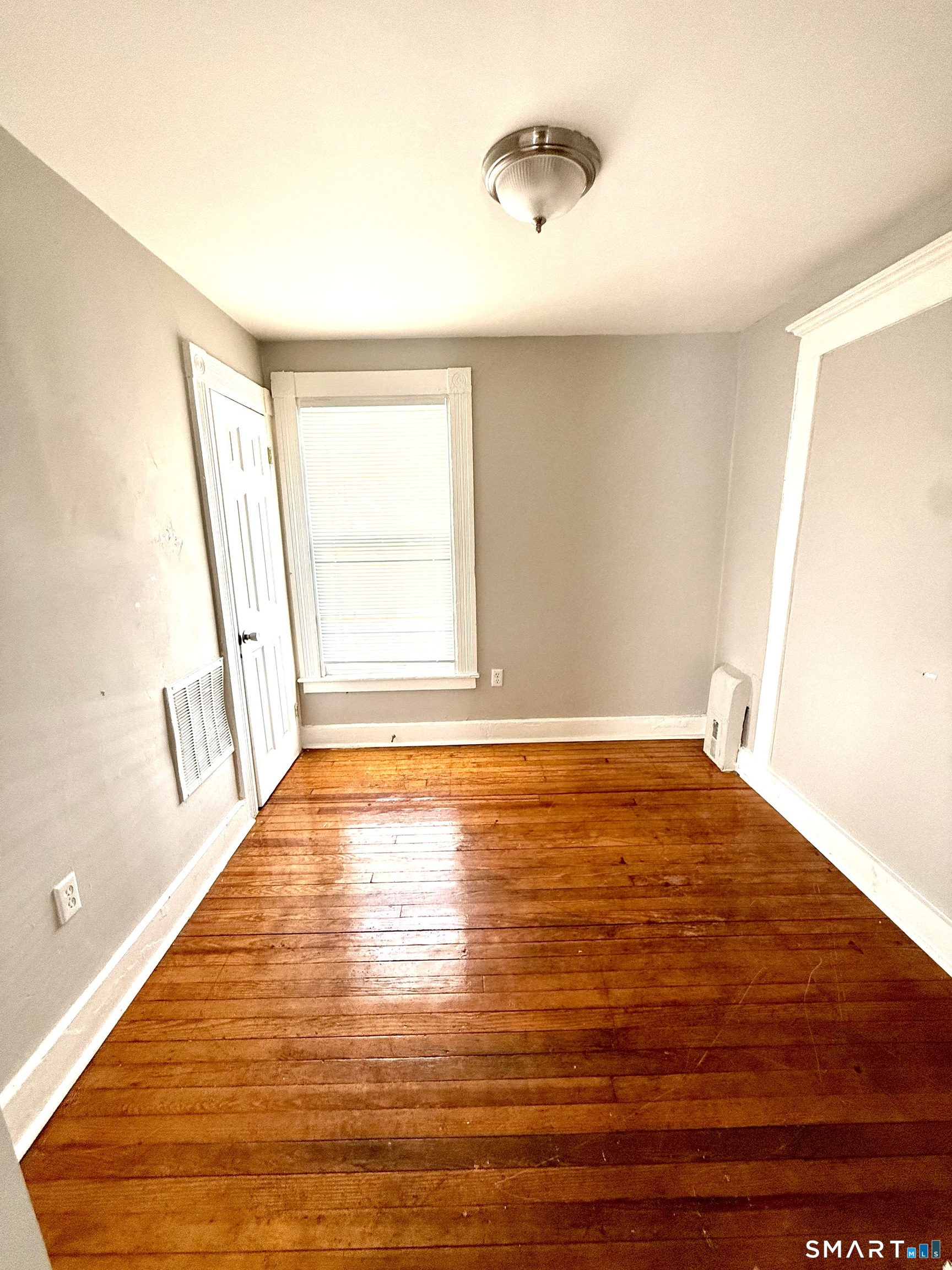 76 3rd Street New Haven, CT 06519 - Photo 5 of 20 a view of an empty room with wooden floor and a window