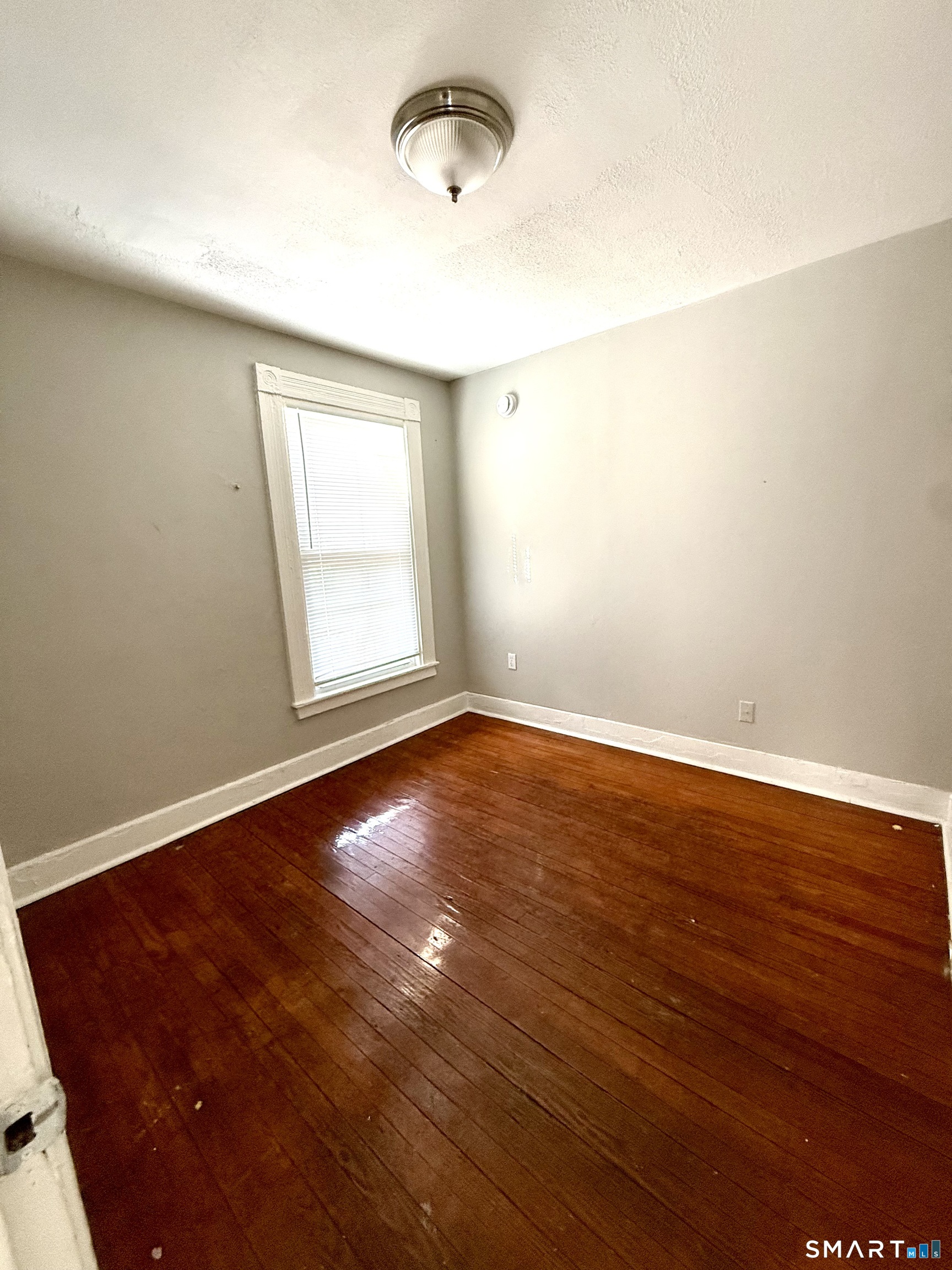 76 3rd Street New Haven, CT 06519 - Photo 9 of 20 an empty room with wooden floor and windows