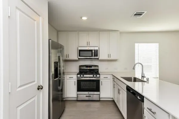 a kitchen with a sink a stove and refrigerator