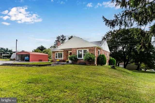 a view of house with outdoor space and car parked