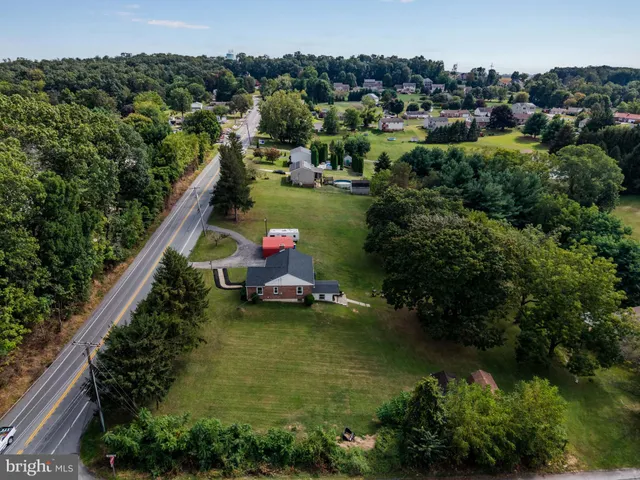 an aerial view of residential house with outdoor space and swimming pool