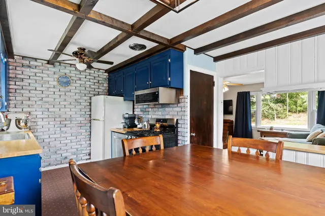 a kitchen with stainless steel appliances wooden floors and wooden cabinets